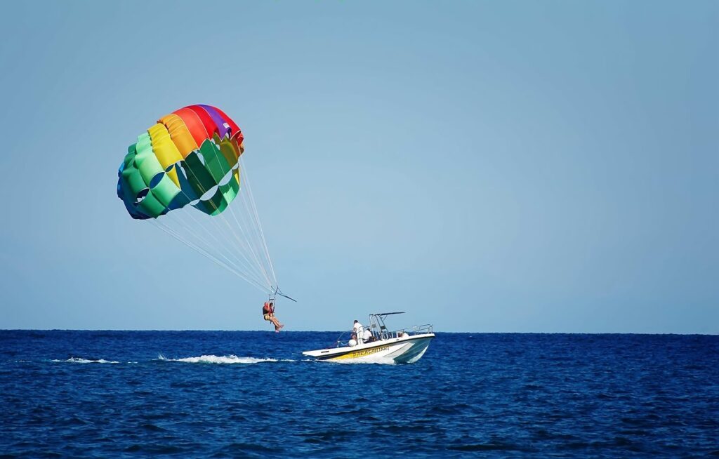 parasailing behind a boat