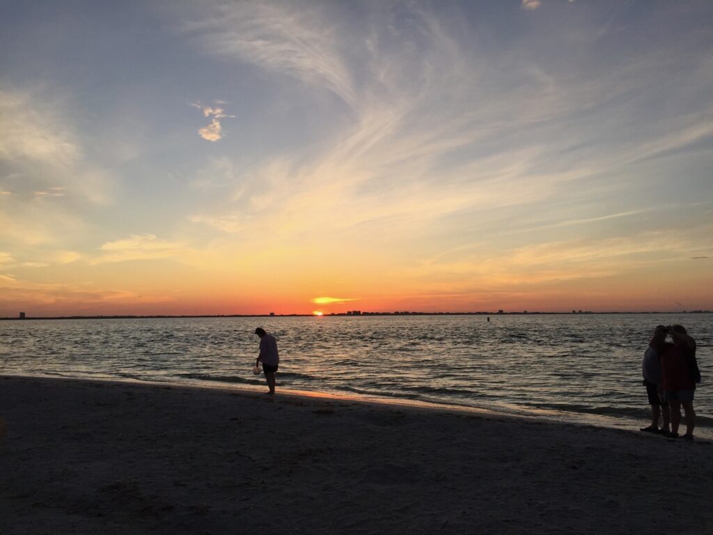 people enjoying the sunset on sanibel island